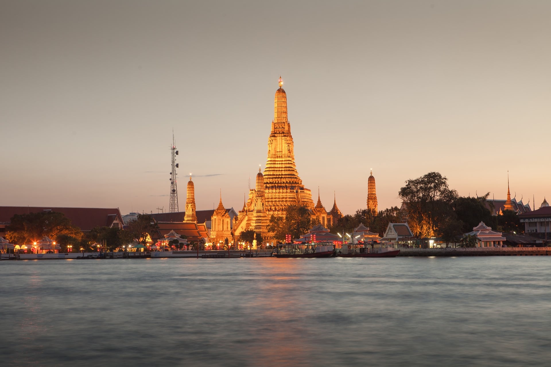 Bangkok skyline at dusk with Wat Arun on the Chao Phraya River, the destination end of the Singapore to Bangkok private jet route