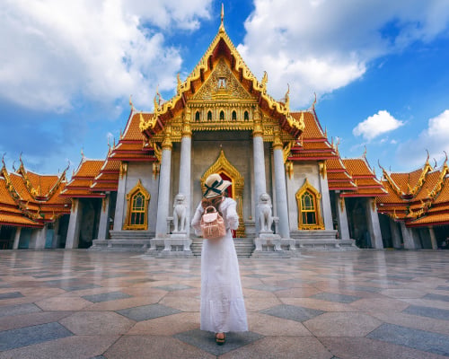 Women tourists at Wat Benchamabophit or the Marble Temple in Bangkok, Thailand.