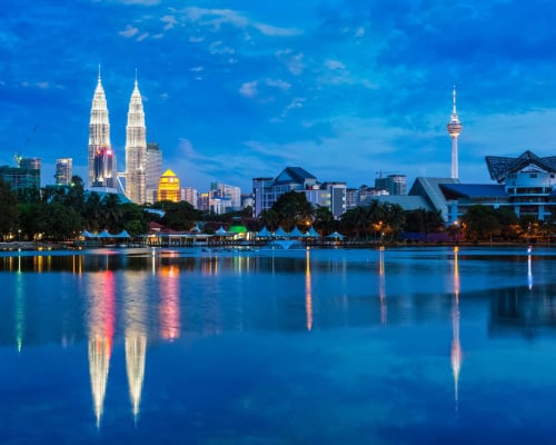 Kuala Lumpur skyline with skyscrapers illuminated in the evening. View over Titiwangsa Lake. Kuala Lumpur, Malaysia